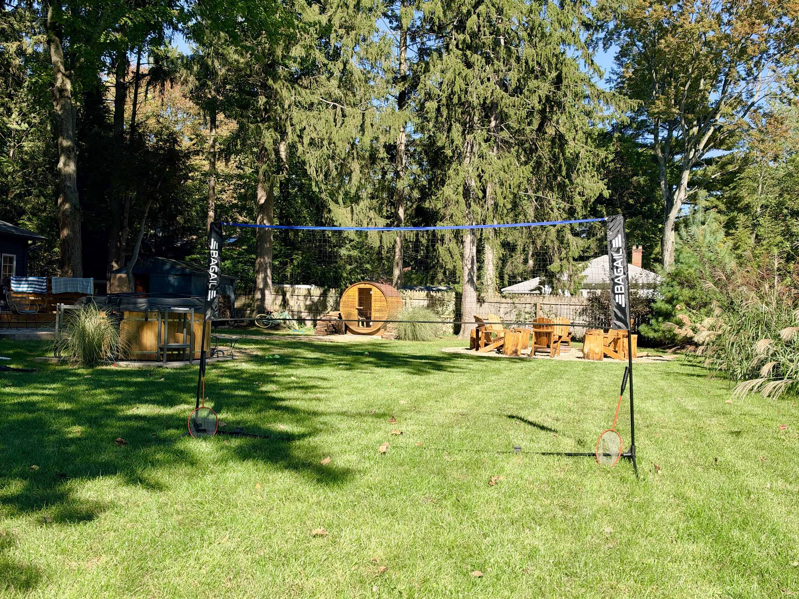 Backyard overview with hot tub, sauna, fire pit and lawn