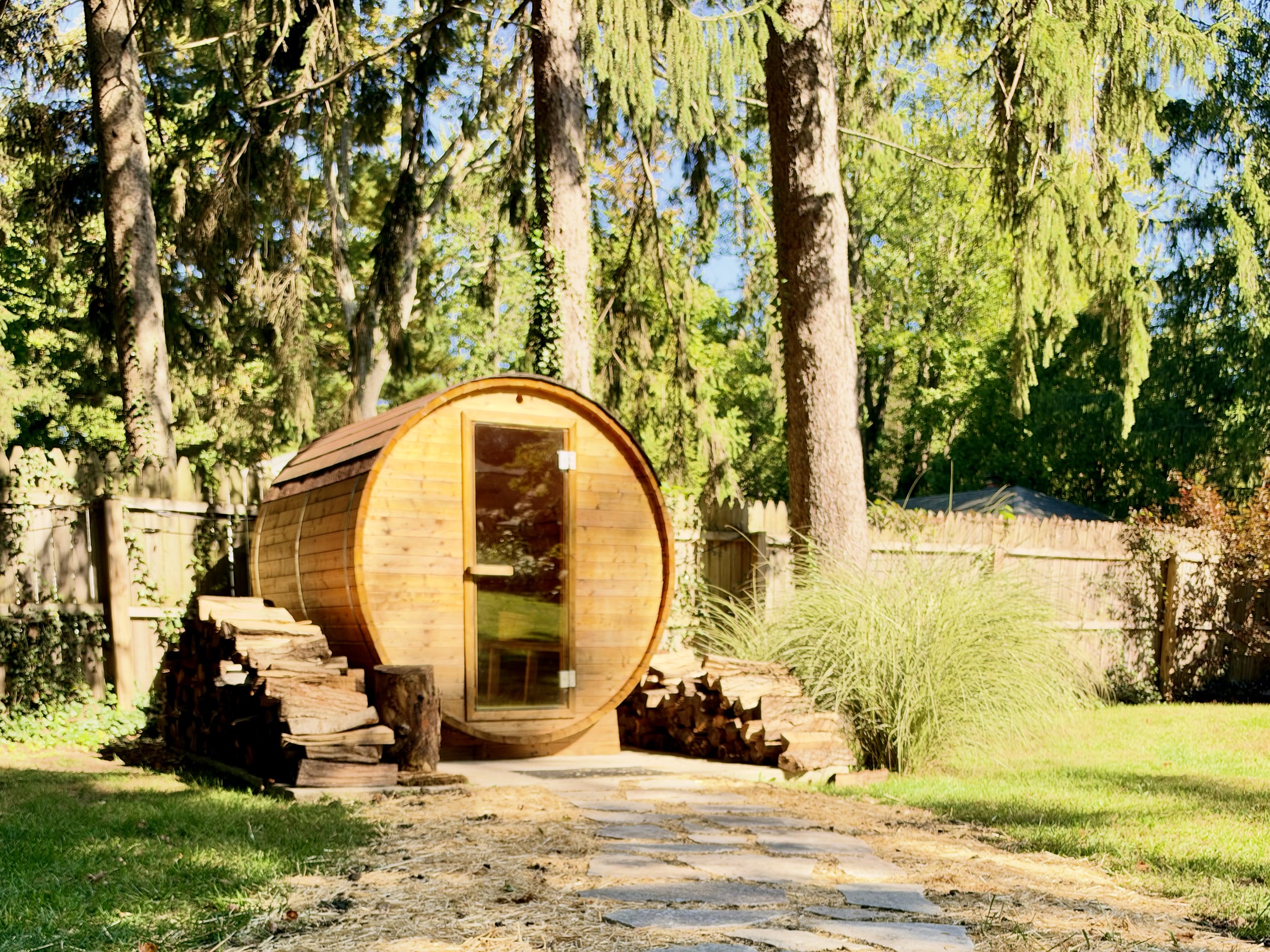 Barrel sauna with stone stepping path in the backyard